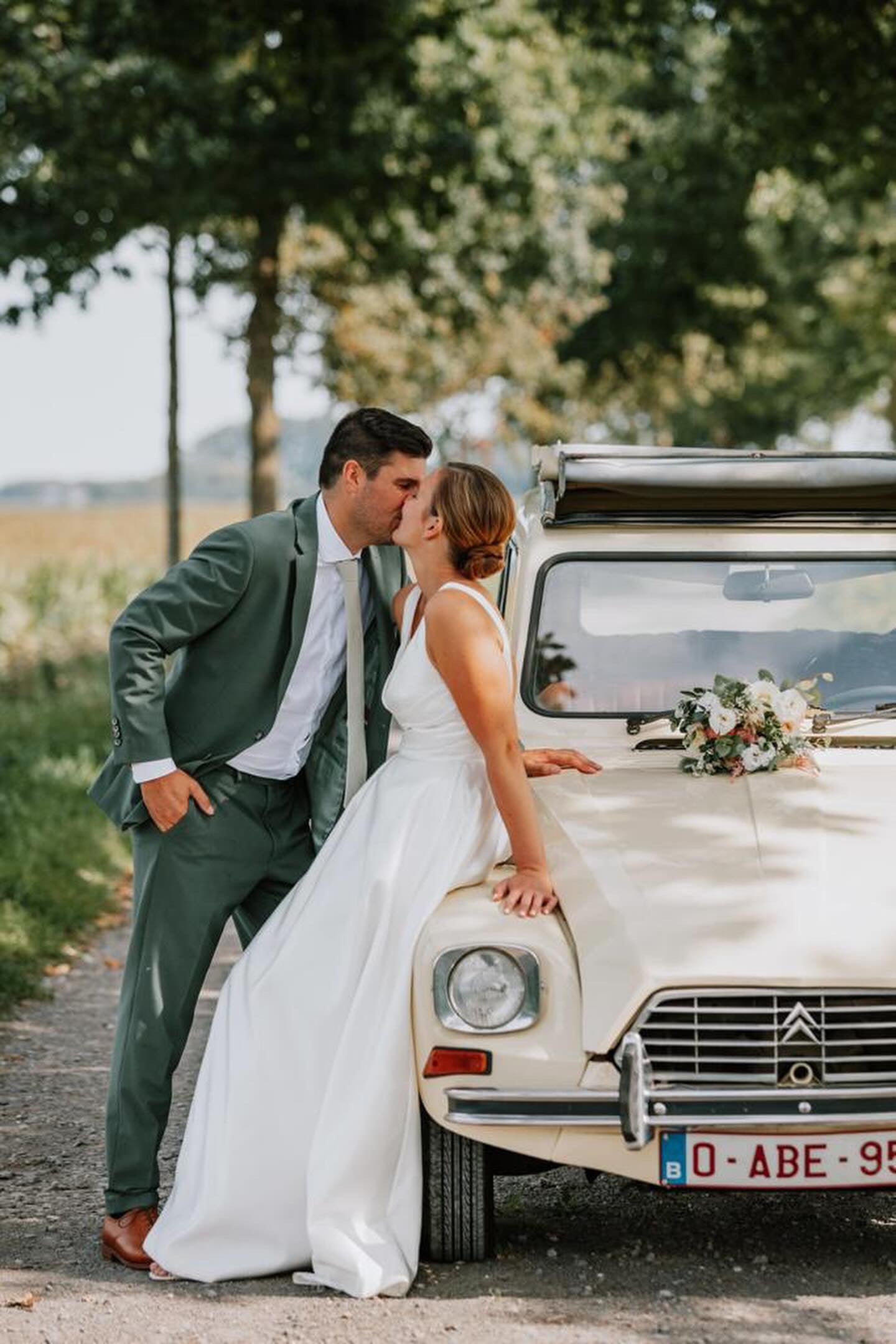 Newlywed couple celebrating, groom in a handcrafted Atelier ACÀN tuxedo.
