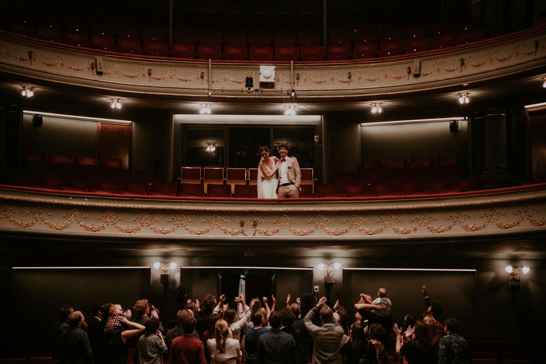 Newlywed couple celebrating, groom in a handcrafted Atelier ACÀN tuxedo.
