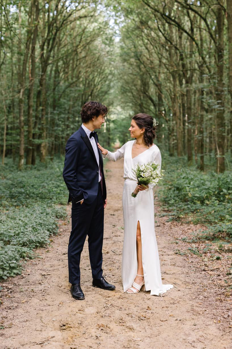 Newlywed couple celebrating, groom in a handcrafted Atelier ACÀN tuxedo.