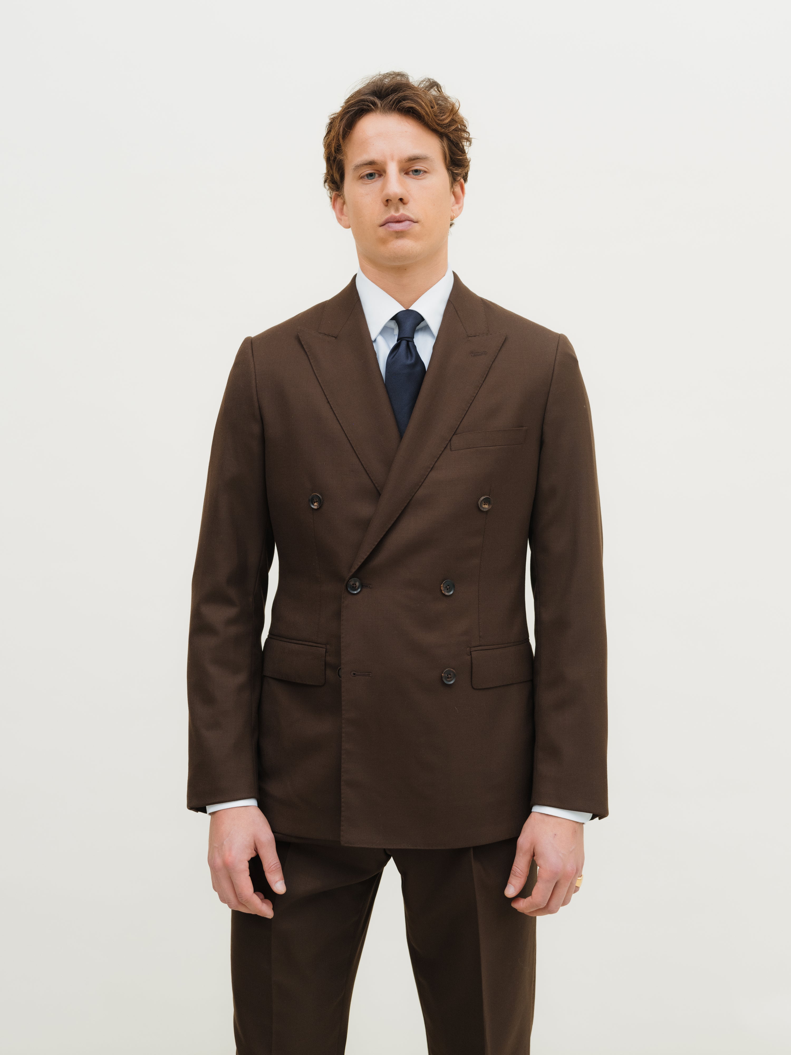 Luxury suits in an array of styles, from refined solids to subtle and bold patterns, at Atelier ACÀN in Ghent and Antwerp.
