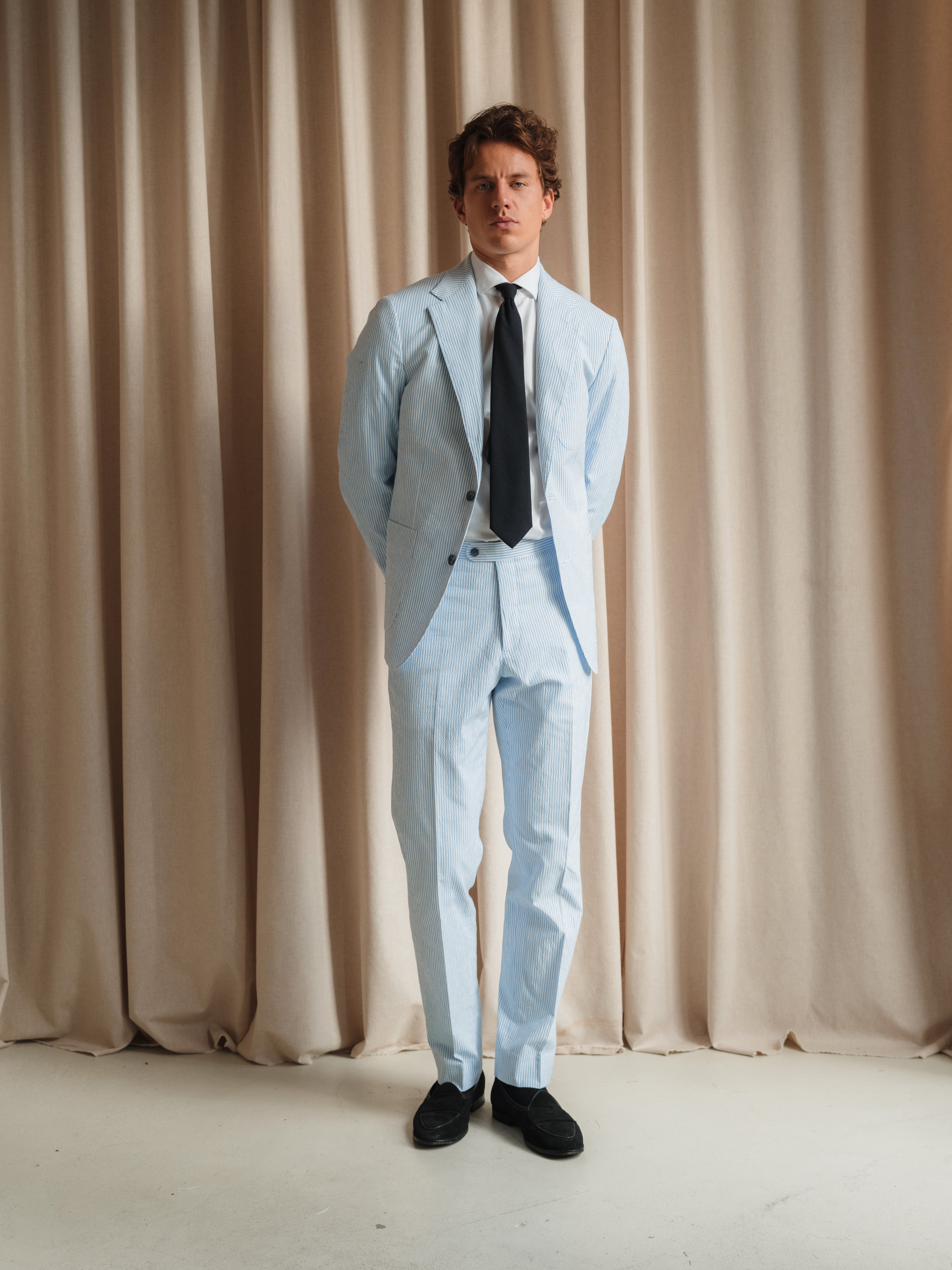 A showcase of tailored menswear, highlighting expert craftsmanship and diverse styling options.