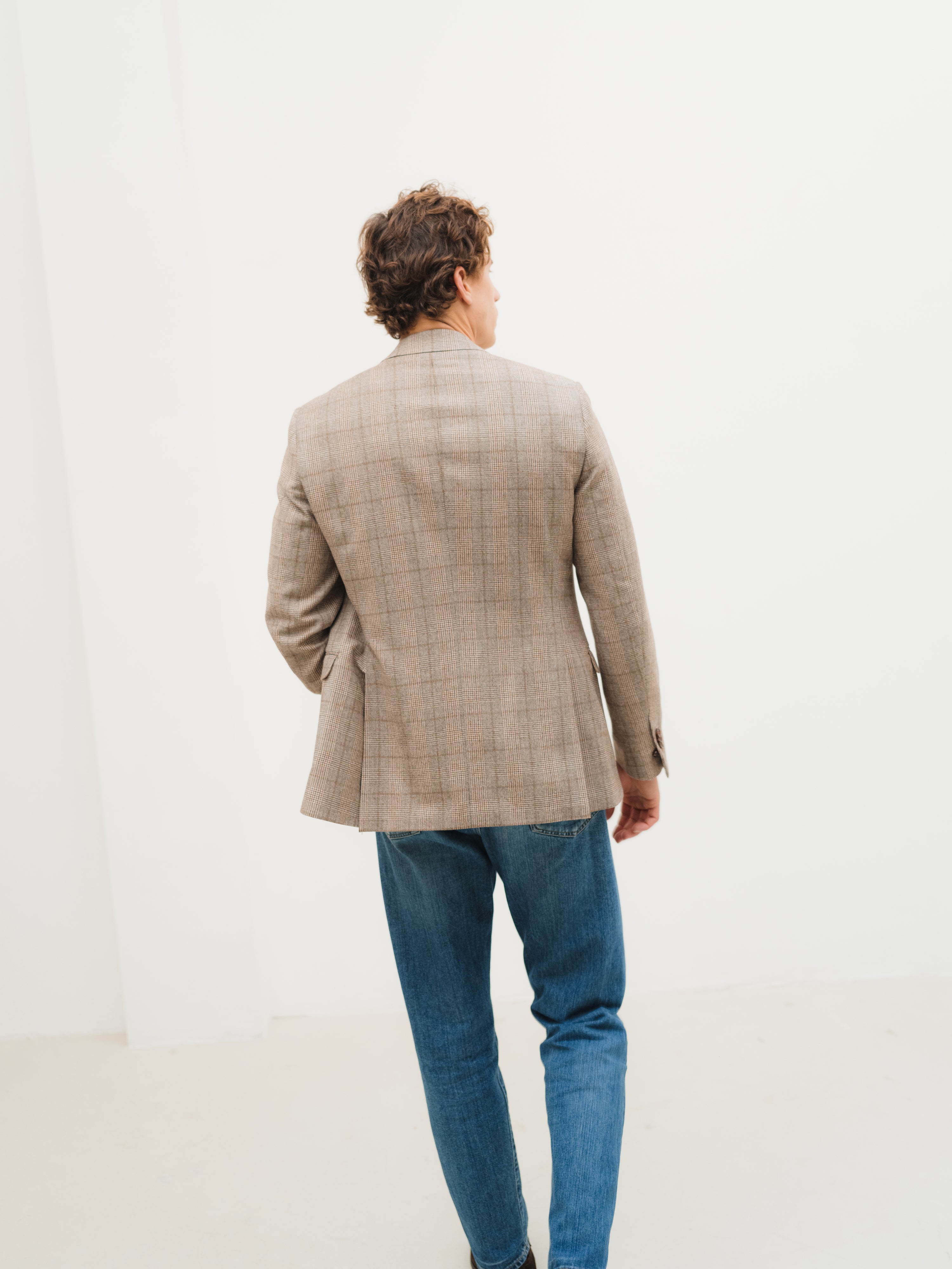 Luxury suits in an array of styles, from refined solids to subtle and bold patterns, at Atelier ACÀN in Ghent and Antwerp.