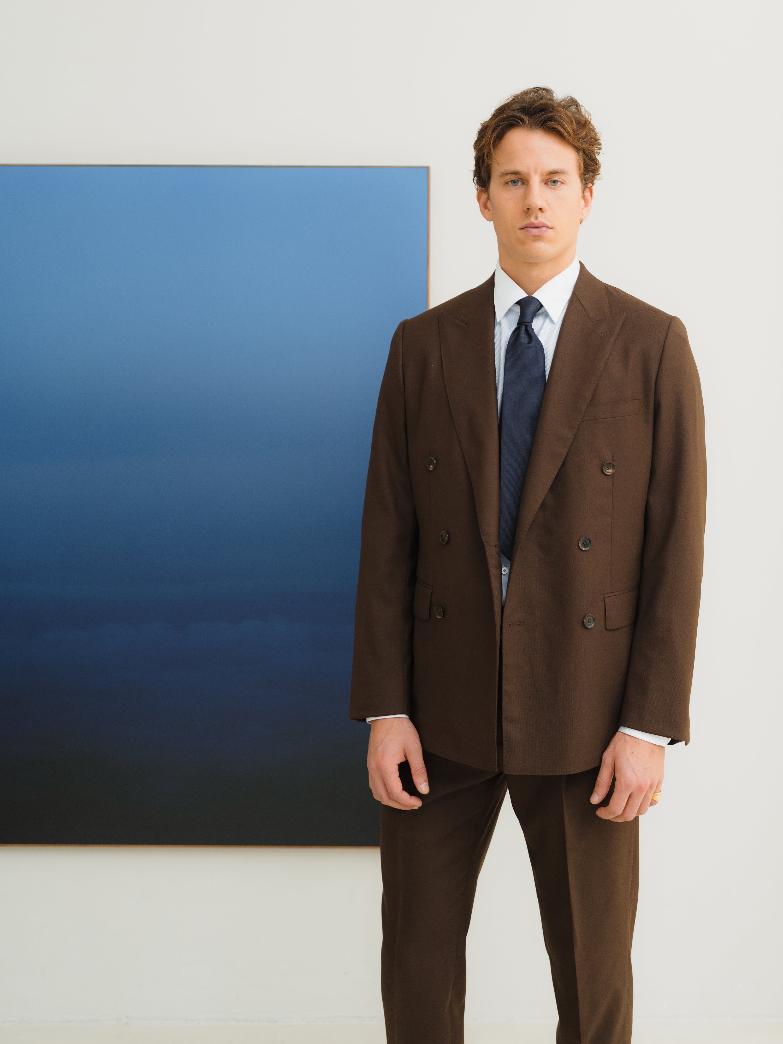 Custom-made suits in rich textures and shades, crafted with precision at Atelier ACÀN in Antwerp and Ghent.