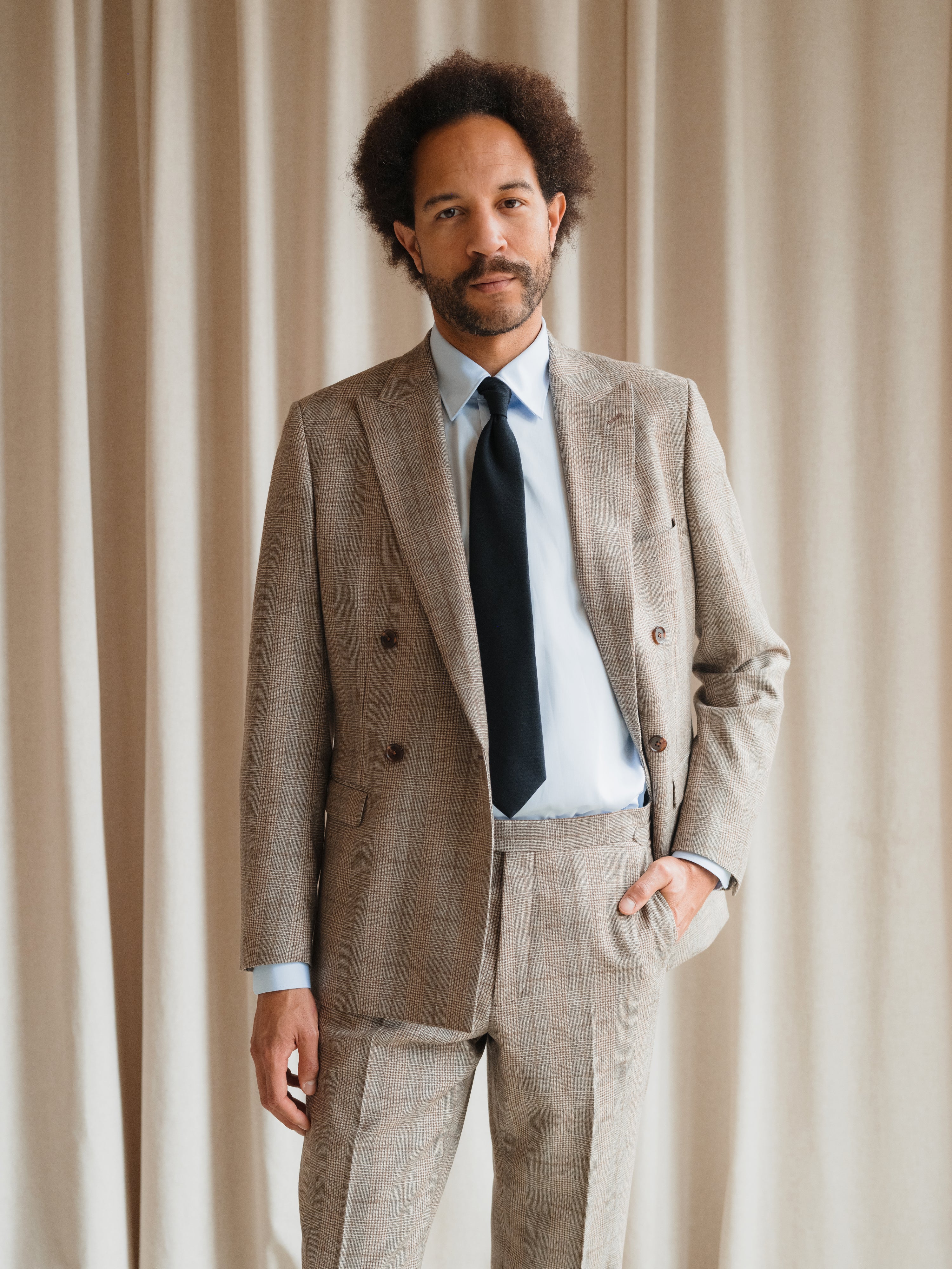 Bespoke suits in a variety of colors and styles, tailored by Atelier ACÀN in Antwerp and Ghent.
