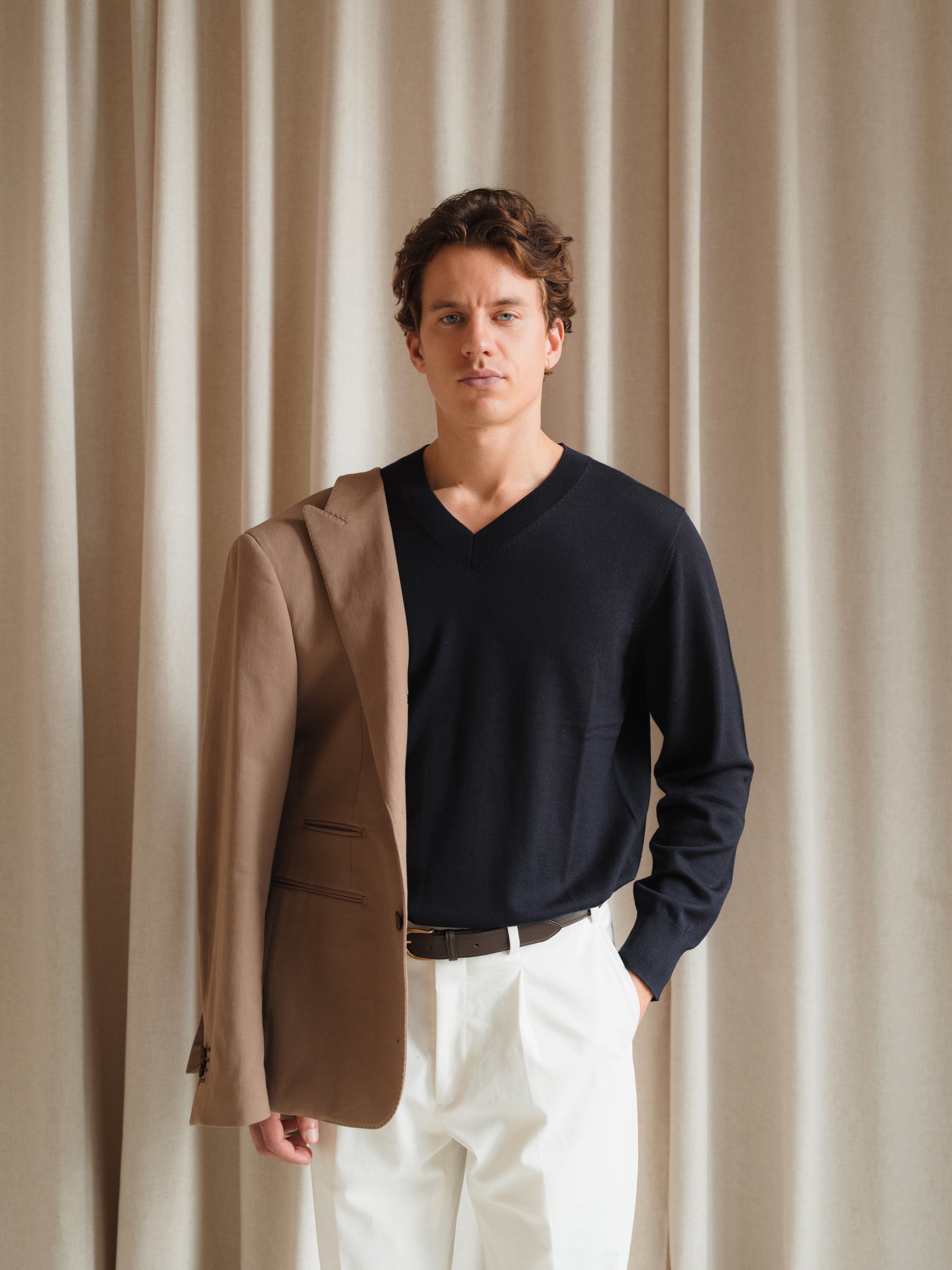 Custom-made suits in rich textures and shades, crafted with precision at Atelier ACÀN in Antwerp and Ghent.