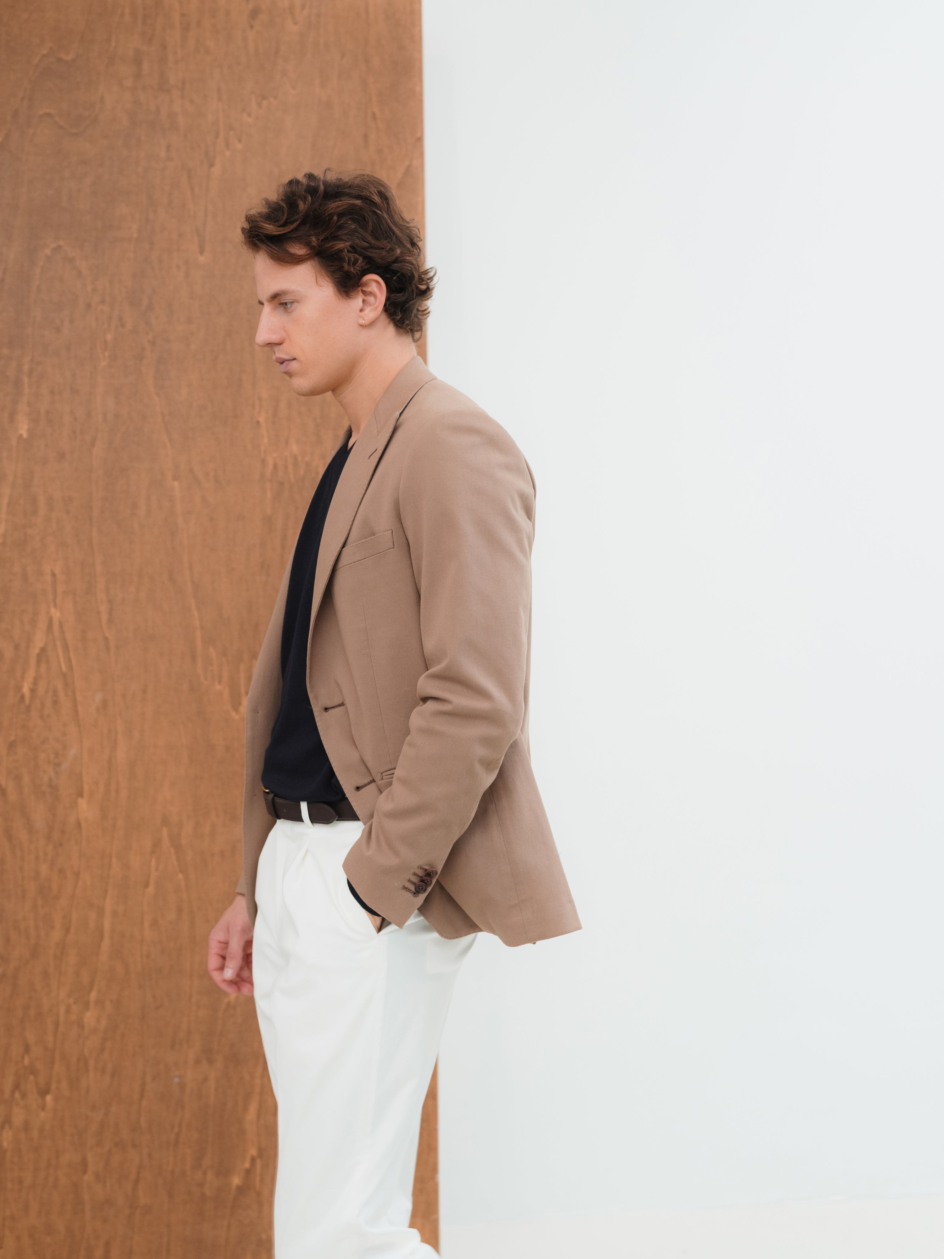 Custom-made suits in rich textures and shades, crafted with precision at Atelier ACÀN in Antwerp and Ghent.