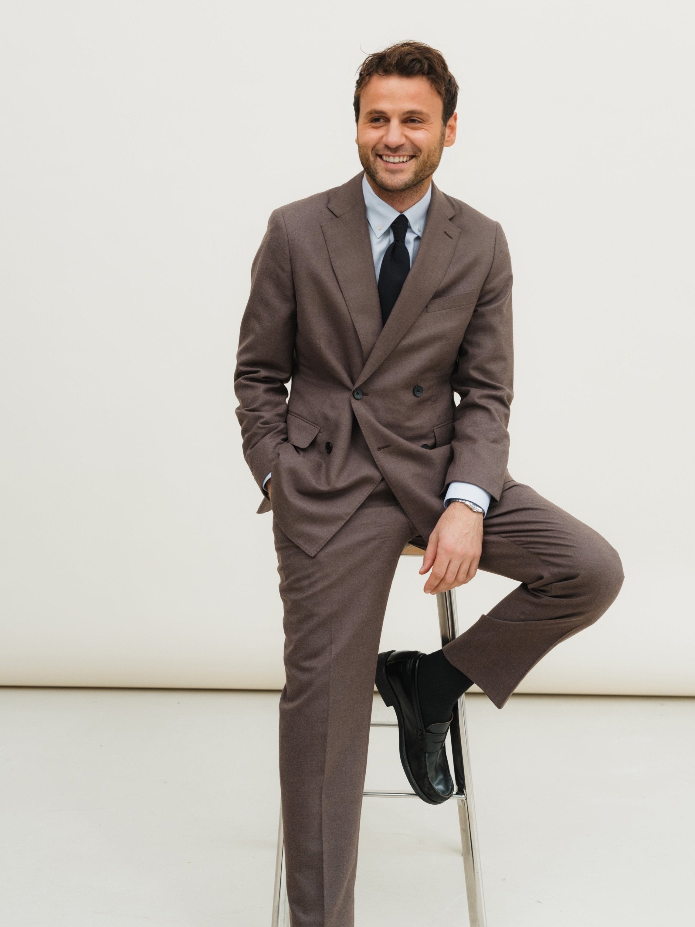 Tailored suits in a variety of colors and patterns, designed for business, weddings, and formal occasions.