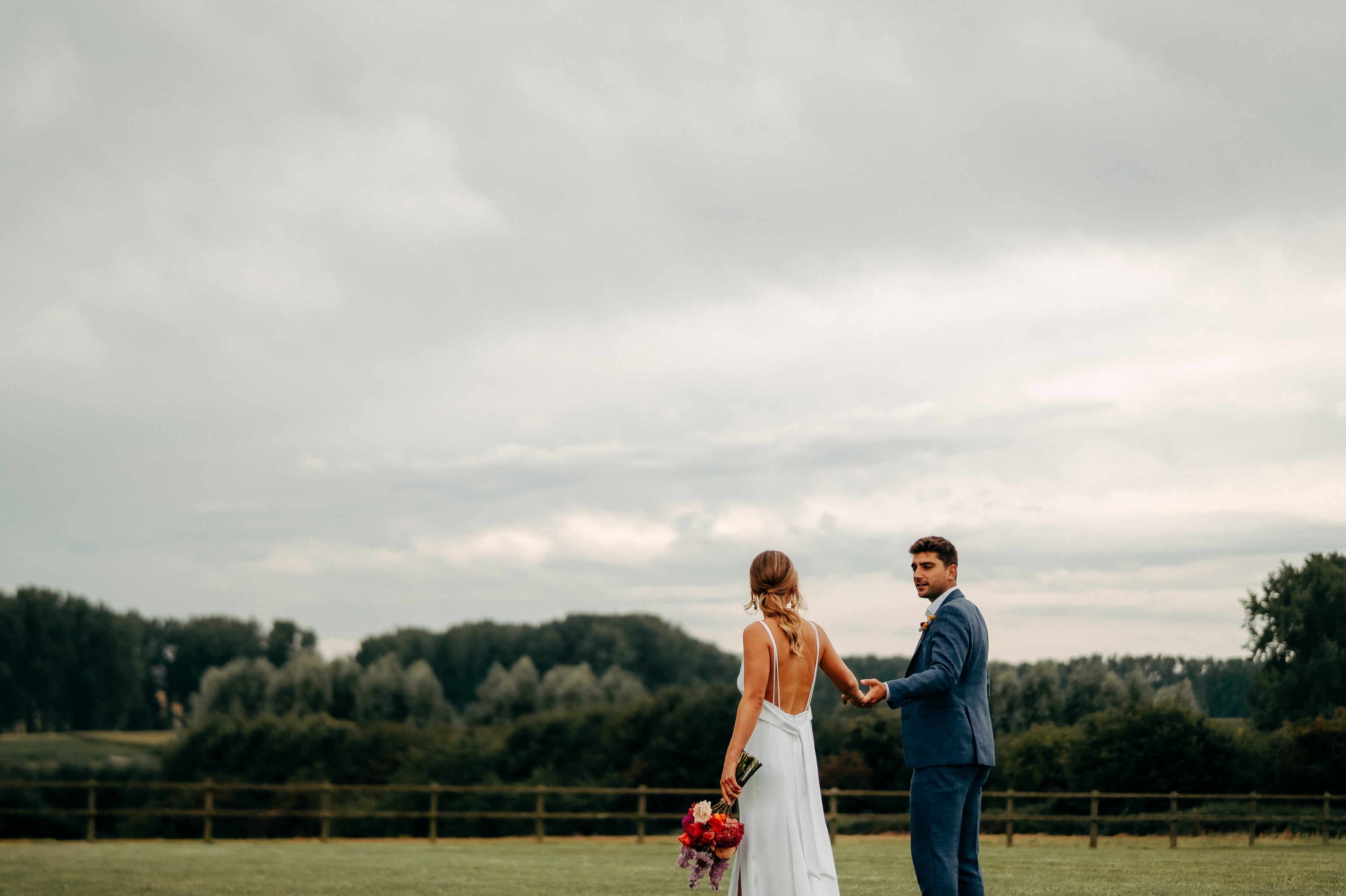 Newlywed couple celebrating, groom in a handcrafted Atelier ACÀN tuxedo.