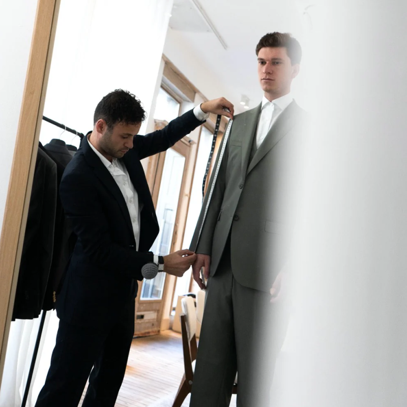 Atelier ACÀN’s expert tailor handcrafting a custom suit in our Antwerp studio.